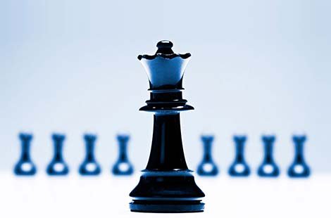 blue-toned chess queen stands in front of a row of pawns on a soft focus - Women's Leadership Excellence