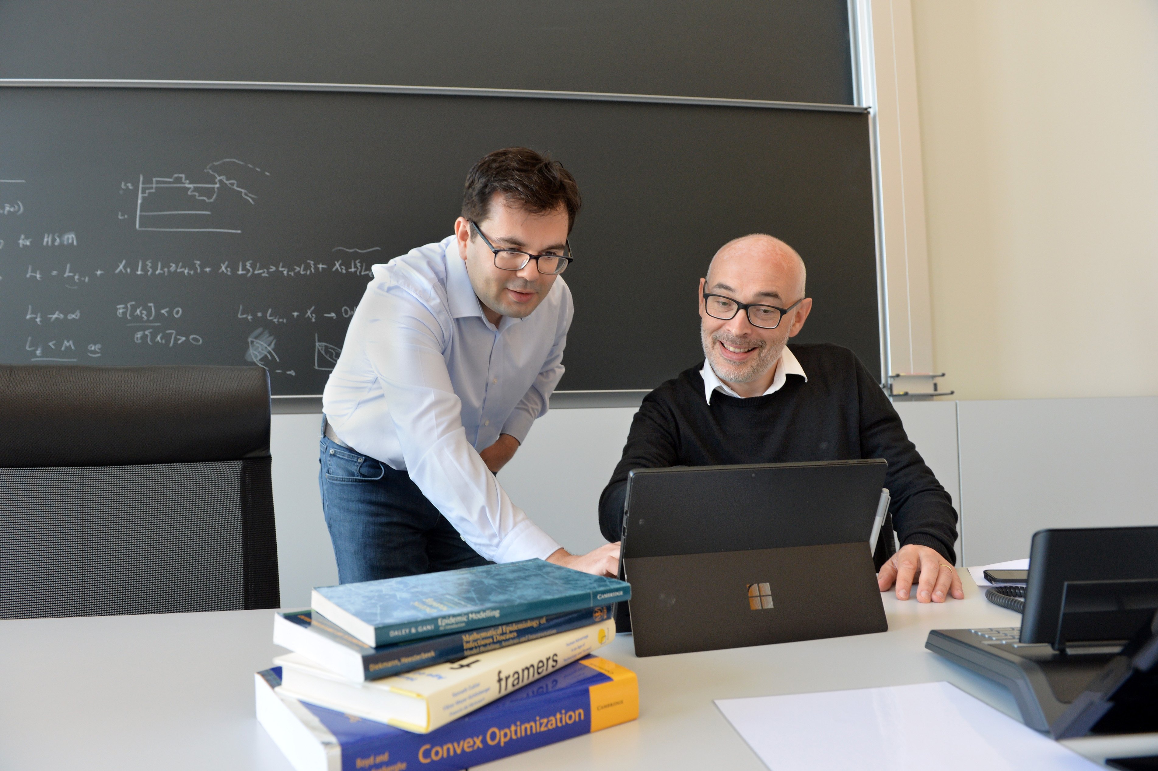 two researchers look at laptop