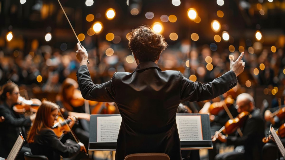 A music conductor leading an orchestra