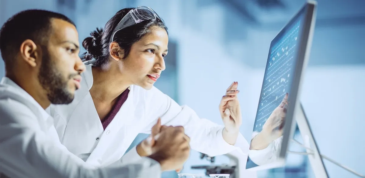 Scientists looking at a screen