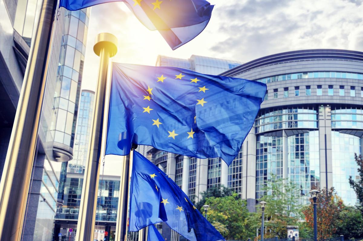 Flags of the European Union flying in front of the European Parliament in Brussels.