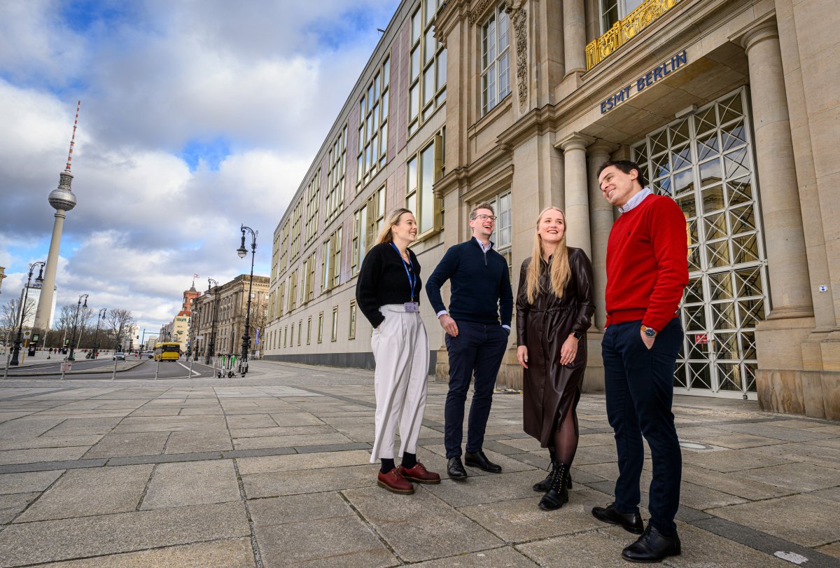 MBA students talking and standing in front of the ESMT building
