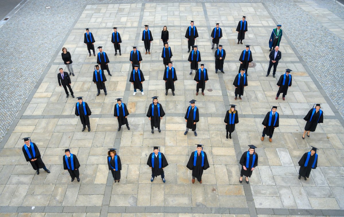 Overhead view of students in ceremonial graduation clothing.