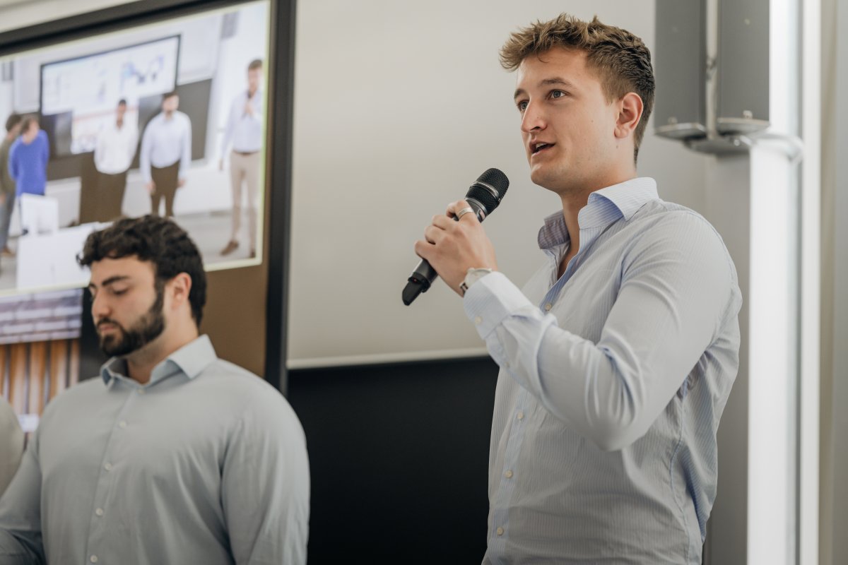 Mid-twenties student giving a speech at ESMT Berlin