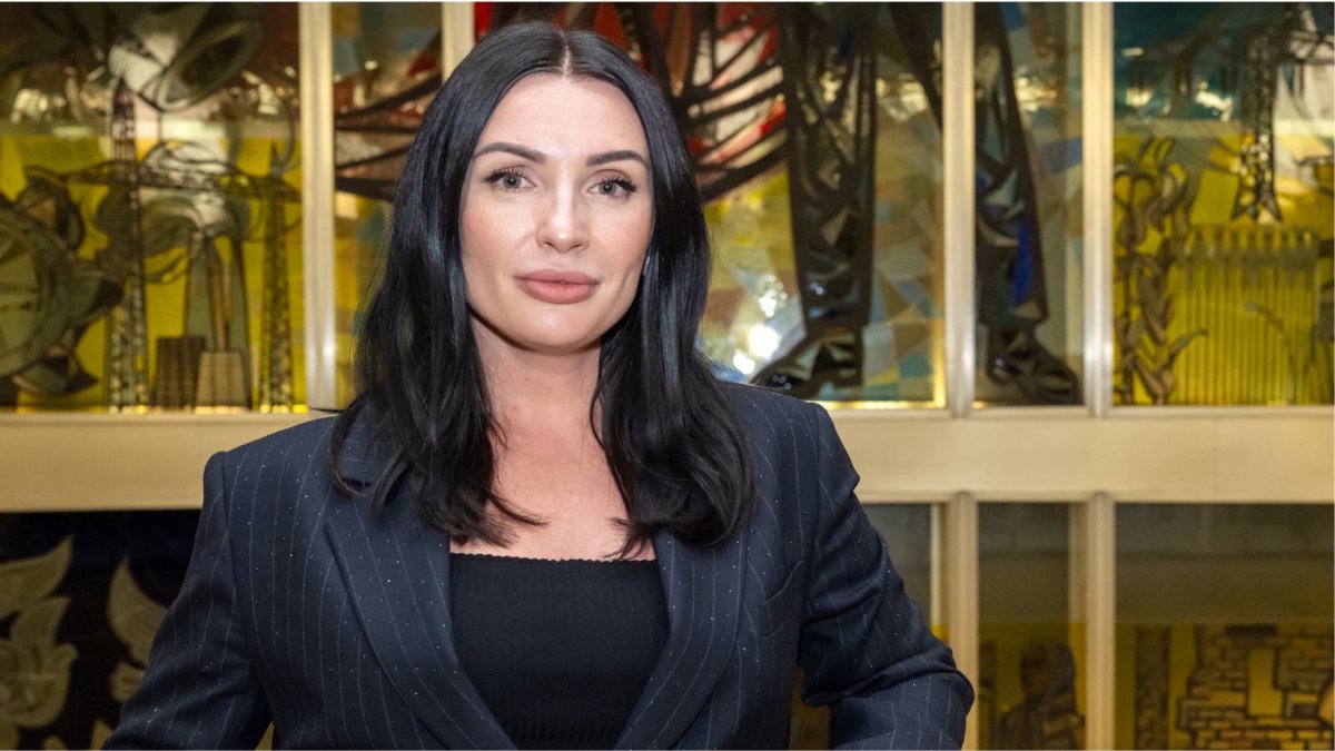 Global Online MBA alum Maryna Salomatina, Class of 2024, standing in front of the stained glass window at ESMT Berlin