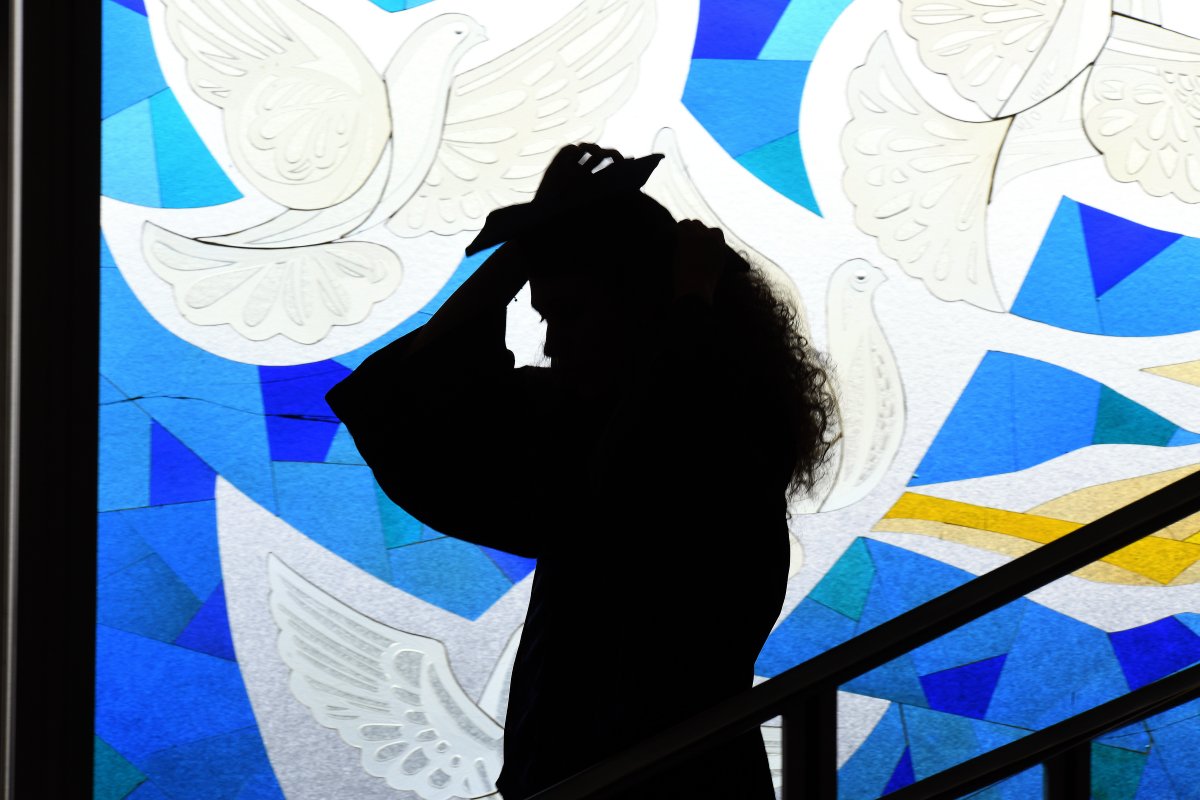 Graduating woman in front of the stained glass window at ESMT Berlin