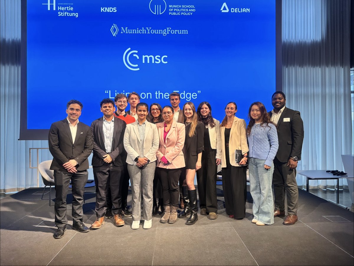 A group of ESMT master's and MBA students standing on stage at the Munich Young Forum 
