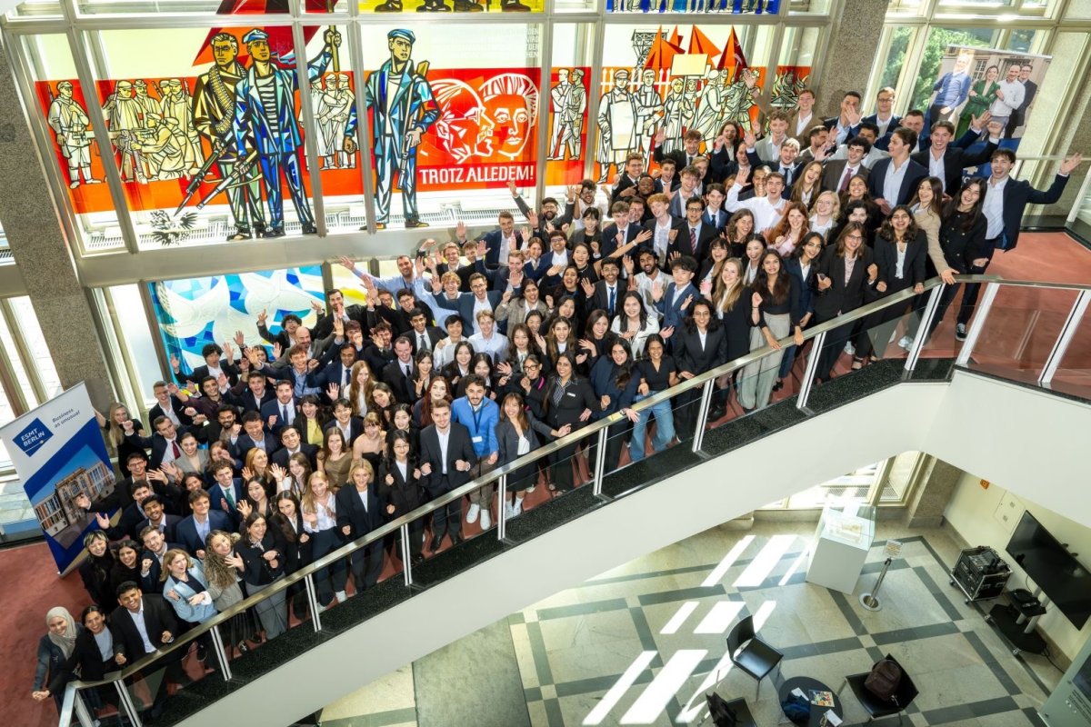 The ESMT master's students from the Class of 2027 gathering on the staircase for a group photo