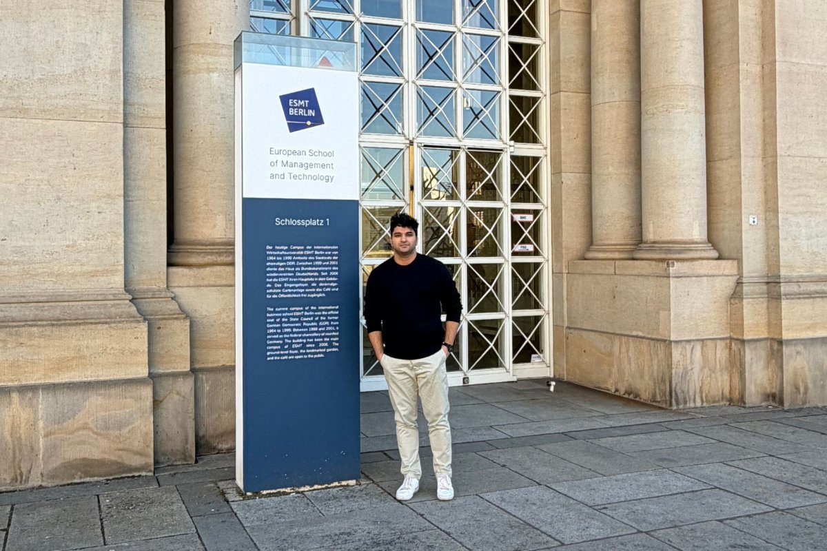 ESMT Full-time MBA student Rishabh Babbar standing outside the main campus building 