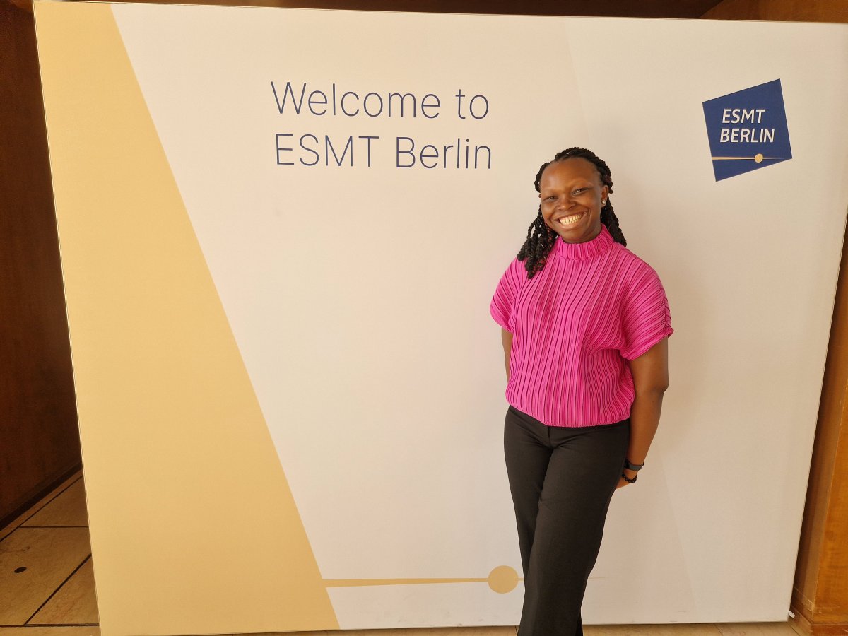 ESMT Berlin Part-time MBA student Funmi Odunowo on the school campus. She is wearing pink and smiling.