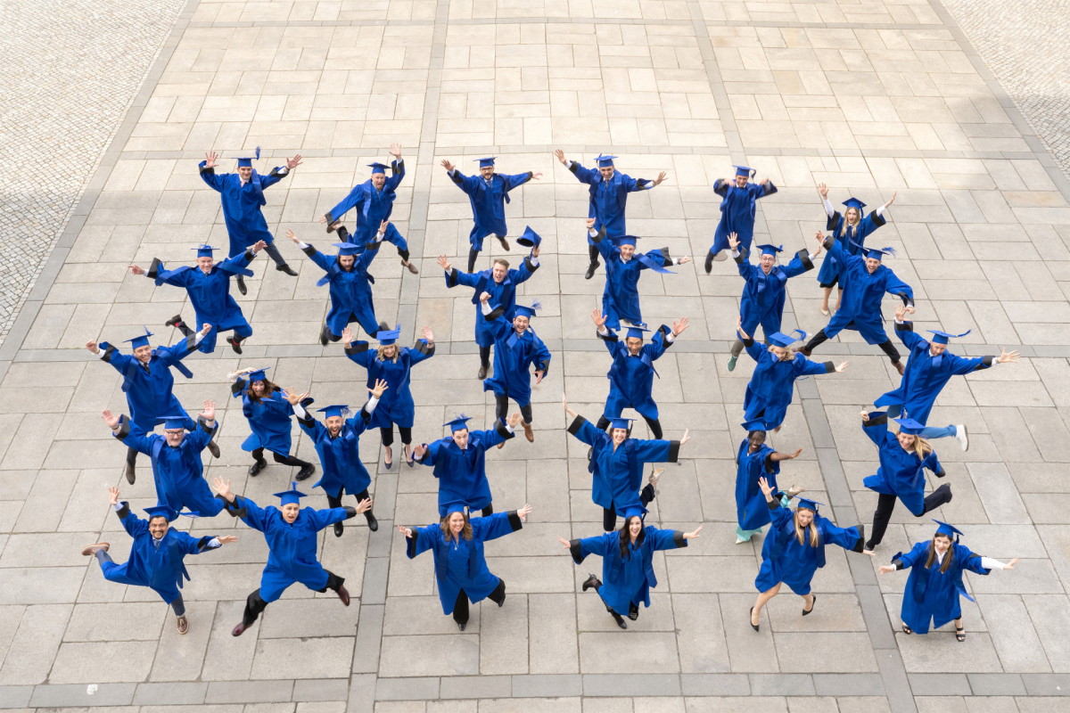The ESMT Berlin Executive MBA Class of 2026 celebrating graduation in their robes and mortarboards