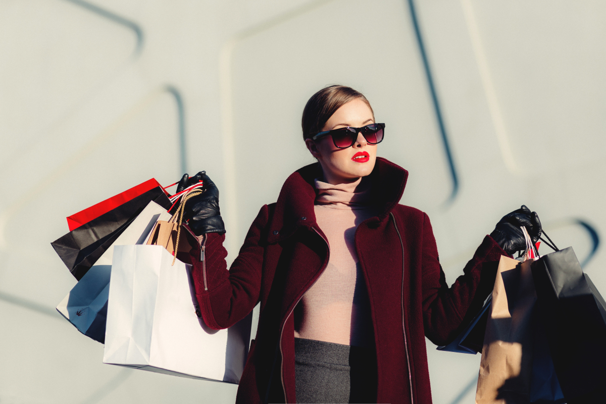 well-dressed person in sunglasses after a shopping spree