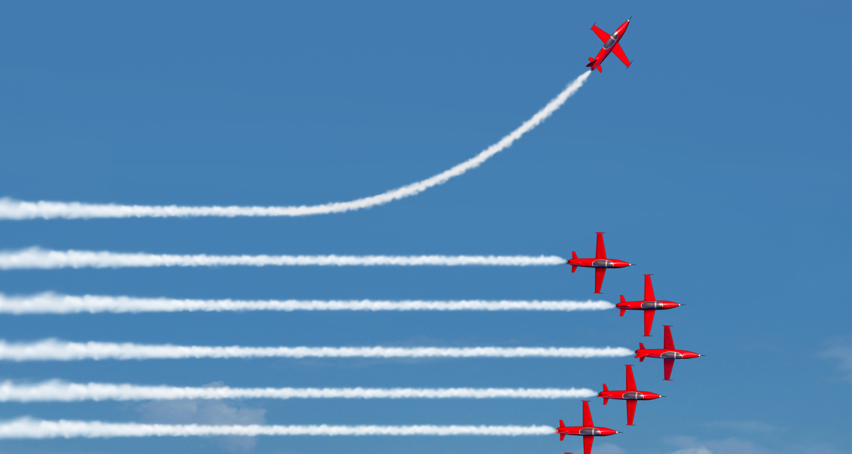 Planes flying in a row with one plane going in it a different direction