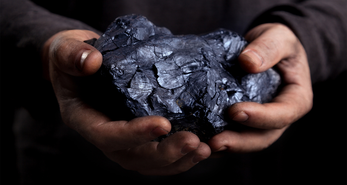 Piece of coal in a man's hands