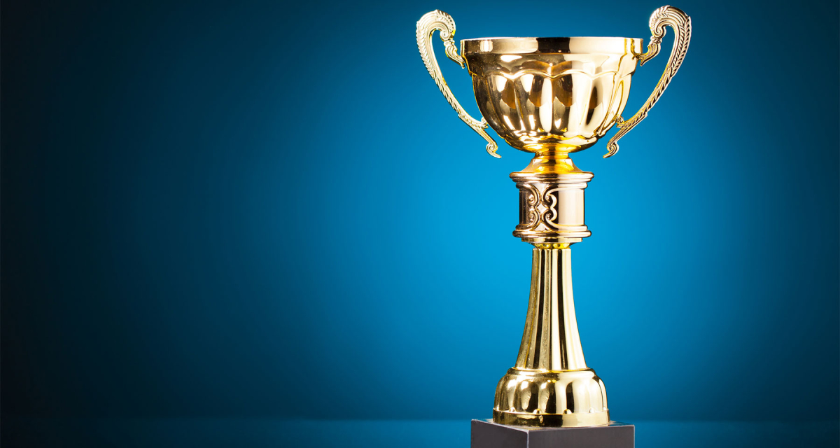 Gold cup trophy on blue background