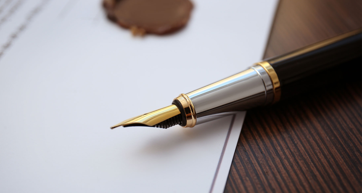Fountain pen lying on paper on a table 