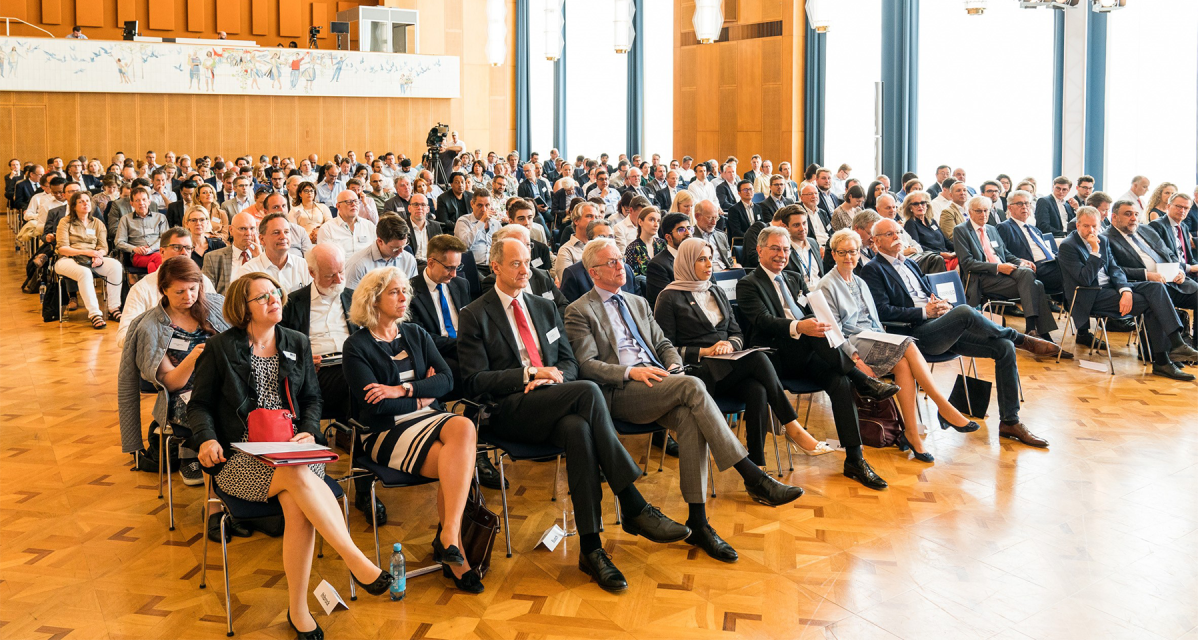 Audience in business attire sitting at a conference