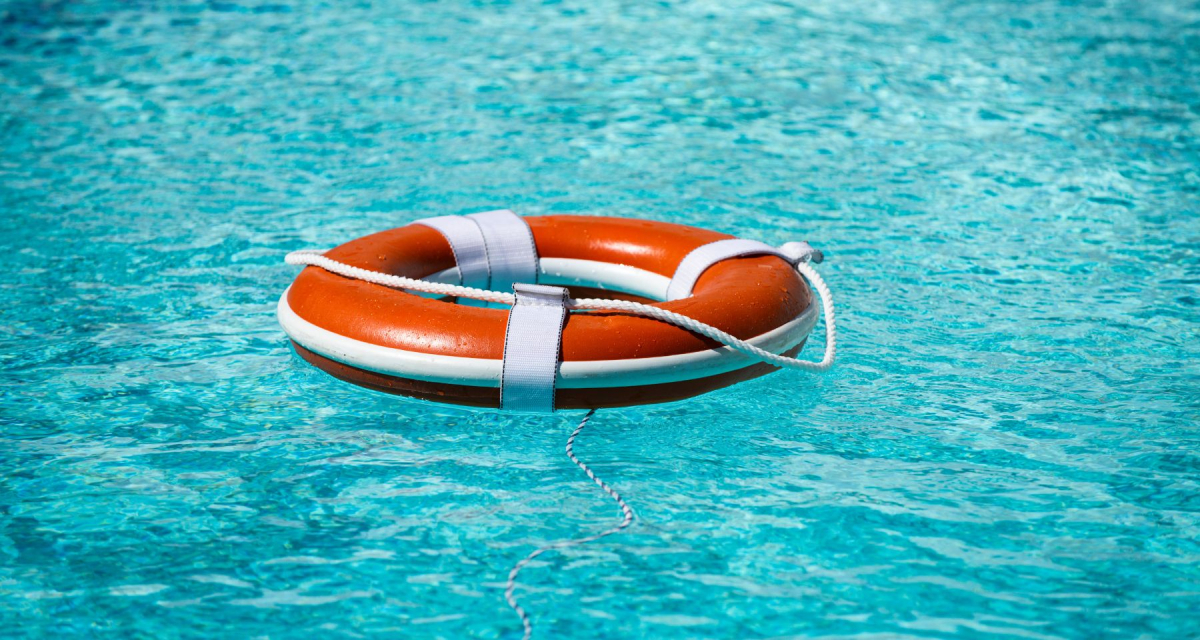 Life buoy in blue swimming pool.