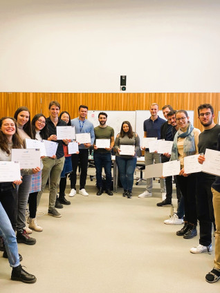 groups of people smiling into camera and holding their certificates up