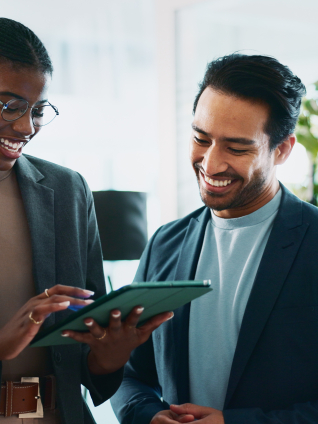 A trio of business professionals reviewing information on a tablet in a professional workspace.