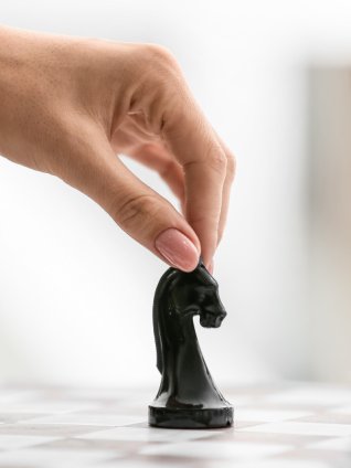 female hand is moving a chess piece