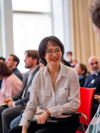Full-time MBA student Lindy Lin at an ESMT Berlin career fair, smiling with another course mate