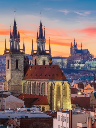 image of downtown Prague in the early evening, looking back at the castle on the hill