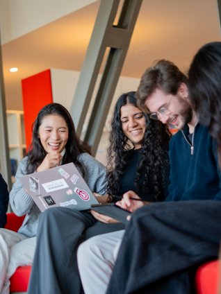 ESMT Berlin master's students laughing together in the campus library