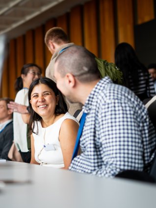 MBA students talking together in an ESMT Berlin auditorium during the annual Berlin Experience Week