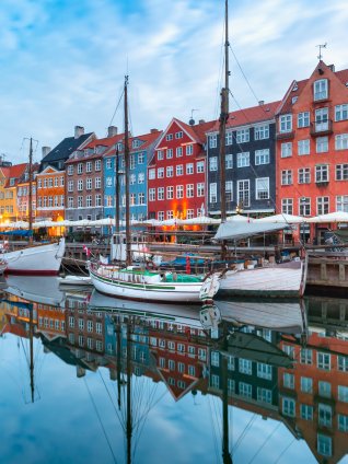 An image of brightly colored, 17th-century canal houses in Nyhavn, the waterfront district in Copenhagen, Denmark
