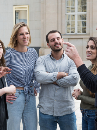 6 people in front of the campus building