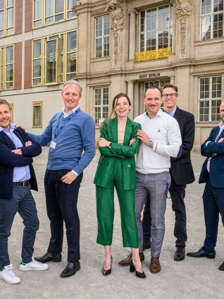 Executive MBA students posing in front of ESMT's building in Berlin, Germany. 