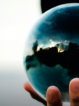 This is a photo of a man holding a crystal ball.