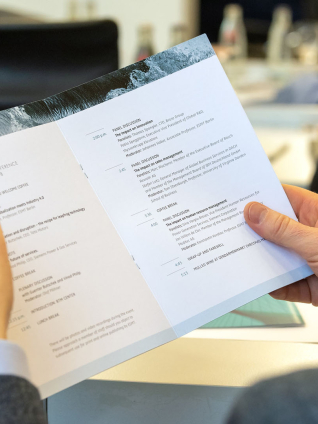 Person reading the BTM conference program