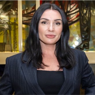 Global Online MBA alum Maryna Salomatina, Class of 2024, standing in front of the stained glass window at ESMT Berlin