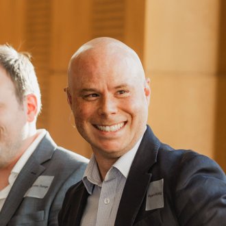 Full-time MBA alum Ryan Krog speaking on stage as part of a panel at the ESMT Berlin Annual Alumni Meeting