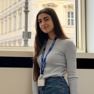 ESMT Part-time MBA student Sophie Khalil in a lecture room on the ESMT campus, in front of a view of the Humboldt Forum