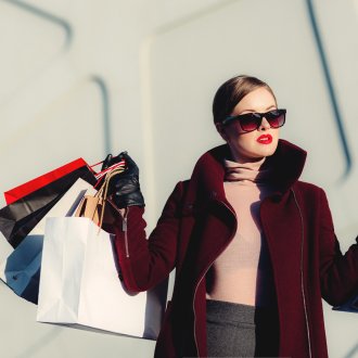 well-dressed person in sunglasses after a shopping spree