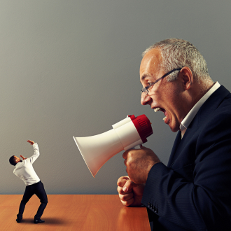Man shouting at another man with megaphone 