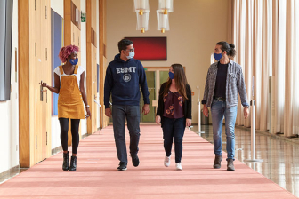MBA students walking with masks on