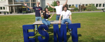 MIM students sitting on table behind ESMT letters