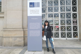 Shiyan Li standing in front of ESMT building