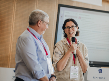 Man and woman at a conference at ESMT Berlin