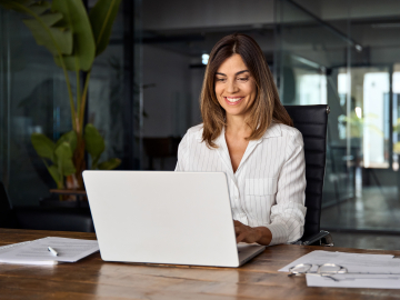 business woman CEO using laptop application for work at table workspace in office