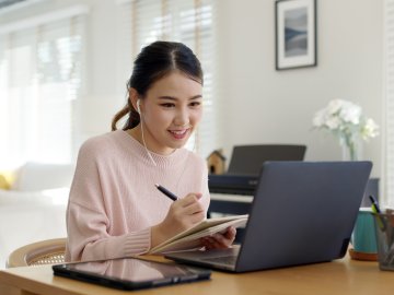 Young female student learning on laptop
