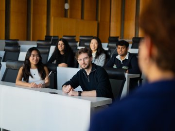 A small group of master's student at ESMT Berlin, in a lecture hall