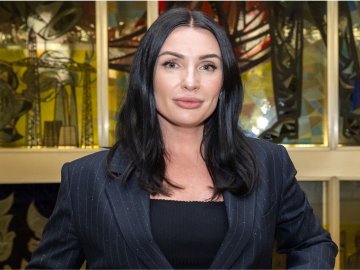 Global Online MBA alum Maryna Salomatina, Class of 2024, standing in front of the stained glass window at ESMT Berlin