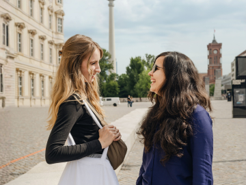 Two ESMT Berlin students talking outside of the campus building in Berlin