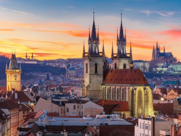 image of downtown Prague in the early evening, looking back at the castle on the hill