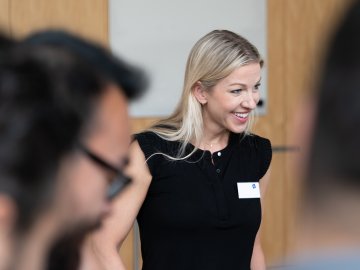 An ESMT Berlin Global Online MBA student. She is taking part in the Berlin Experience Week and smiling while being part of a group project